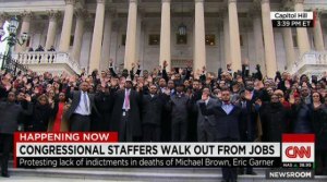 Staffers raise their hands, gesturing "Hands Up, Don't Shoot."